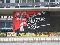 Students are painting graffiti on a wall alongside a road to express their message after the fall of Bangladesh's former Prime Minister Shei...