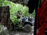 A serviceman of the Motorised Rifle Battalion of the 93rd Kholodnyi Yar Separate Mechanized Brigade of the Ukrainian Armed Forces is sitting...