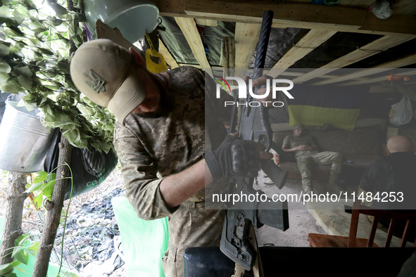 A serviceman of the Motorised Rifle Battalion of the 93rd Kholodnyi Yar Separate Mechanized Brigade of the Ukrainian Armed Forces is holding...