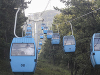 Tourists are riding ropeways at Lianhua Mountain in Dalian, China, on August 15, 2024. (