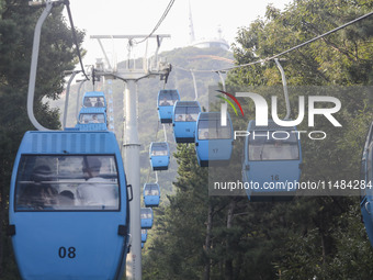 Tourists are riding ropeways at Lianhua Mountain in Dalian, China, on August 15, 2024. (