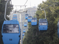 Tourists are riding ropeways at Lianhua Mountain in Dalian, China, on August 15, 2024. (