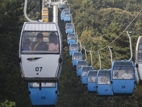 Tourists are riding ropeways at Lianhua Mountain in Dalian, China, on August 15, 2024. (