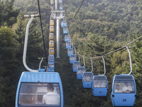 Tourists are riding ropeways at Lianhua Mountain in Dalian, China, on August 15, 2024. (