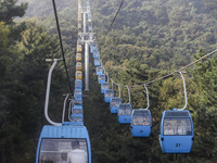 Tourists are riding ropeways at Lianhua Mountain in Dalian, China, on August 15, 2024. (