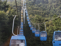 Tourists are riding ropeways at Lianhua Mountain in Dalian, China, on August 15, 2024. (