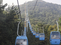 Tourists are riding ropeways at Lianhua Mountain in Dalian, China, on August 15, 2024. (