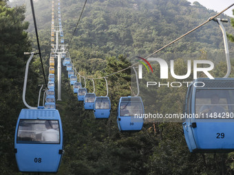 Tourists are riding ropeways at Lianhua Mountain in Dalian, China, on August 15, 2024. (