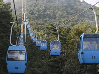 Tourists are riding ropeways at Lianhua Mountain in Dalian, China, on August 15, 2024. (