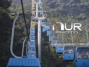 Tourists are riding ropeways at Lianhua Mountain in Dalian, China, on August 15, 2024. (