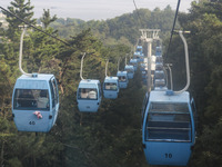 Tourists are riding ropeways at Lianhua Mountain in Dalian, China, on August 15, 2024. (