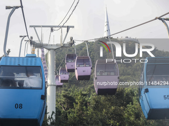 Tourists are riding ropeways at Lianhua Mountain in Dalian, China, on August 15, 2024. (