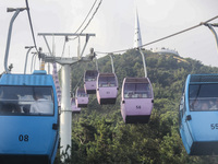 Tourists are riding ropeways at Lianhua Mountain in Dalian, China, on August 15, 2024. (