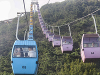 Tourists are riding ropeways at Lianhua Mountain in Dalian, China, on August 15, 2024. (