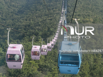 Tourists are riding ropeways at Lianhua Mountain in Dalian, China, on August 15, 2024. (