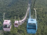 Tourists are riding ropeways at Lianhua Mountain in Dalian, China, on August 15, 2024. (