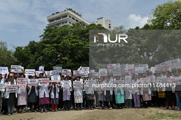 Medical professionals are shouting slogans and holding placards to protest against the rape and murder of a trainee medic at a government-ru...