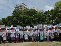 Medical professionals are shouting slogans and holding placards to protest against the rape and murder of a trainee medic at a government-ru...