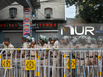 Police are seen during a protest demonstration against the brutal rape and murder of a doctor at RG Kar Medical College and Hospital, in Kol...