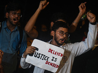 Medical professionals and students are shouting slogans in a protest condemning the rape and murder of a trainee medic at a hospital in Kolk...