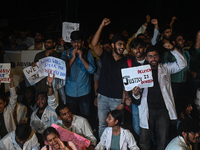 Medical professionals and students are shouting slogans in a protest condemning the rape and murder of a trainee medic at a hospital in Kolk...