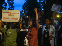 Medical professionals and students are shouting slogans in a protest condemning the rape and murder of a trainee medic at a hospital in Kolk...