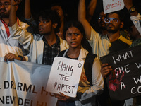 Medical professionals and students are holding placards in a protest condemning the rape and murder of a trainee medic at a hospital in Kolk...