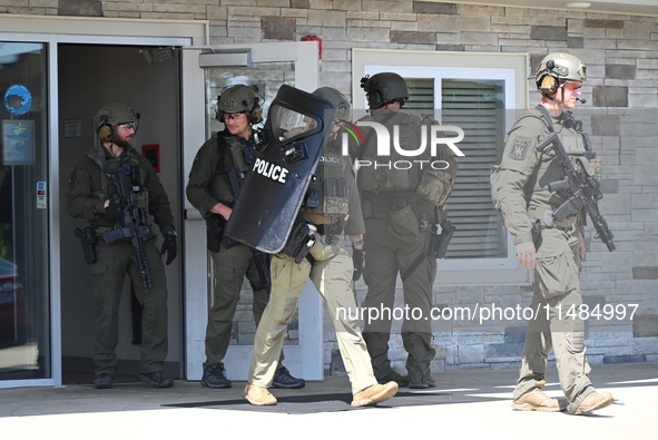 The SWAT team is raiding the WoodSpring Suites hotel in Carol Stream, Illinois, United States, on August 16, 2024. No information is immedia...