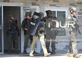 The SWAT team is raiding the WoodSpring Suites hotel in Carol Stream, Illinois, United States, on August 16, 2024. No information is immedia...