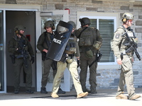 The SWAT team is raiding the WoodSpring Suites hotel in Carol Stream, Illinois, United States, on August 16, 2024. No information is immedia...