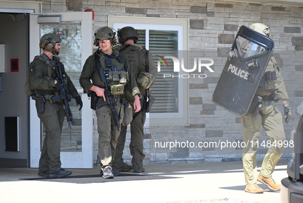 The SWAT team is raiding the WoodSpring Suites hotel in Carol Stream, Illinois, United States, on August 16, 2024. No information is immedia...