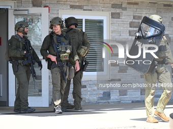 The SWAT team is raiding the WoodSpring Suites hotel in Carol Stream, Illinois, United States, on August 16, 2024. No information is immedia...