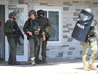 The SWAT team is raiding the WoodSpring Suites hotel in Carol Stream, Illinois, United States, on August 16, 2024. No information is immedia...