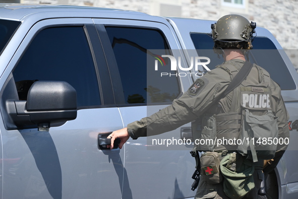 The SWAT team is raiding the WoodSpring Suites hotel in Carol Stream, Illinois, United States, on August 16, 2024. No information is immedia...