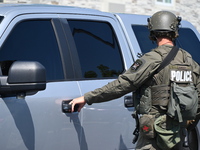 The SWAT team is raiding the WoodSpring Suites hotel in Carol Stream, Illinois, United States, on August 16, 2024. No information is immedia...