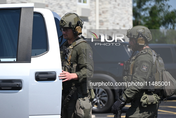 The SWAT team is raiding the WoodSpring Suites hotel in Carol Stream, Illinois, United States, on August 16, 2024. No information is immedia...