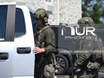 The SWAT team is raiding the WoodSpring Suites hotel in Carol Stream, Illinois, United States, on August 16, 2024. No information is immedia...