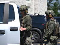 The SWAT team is raiding the WoodSpring Suites hotel in Carol Stream, Illinois, United States, on August 16, 2024. No information is immedia...