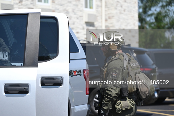 The SWAT team is raiding the WoodSpring Suites hotel in Carol Stream, Illinois, United States, on August 16, 2024. No information is immedia...