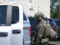 The SWAT team is raiding the WoodSpring Suites hotel in Carol Stream, Illinois, United States, on August 16, 2024. No information is immedia...