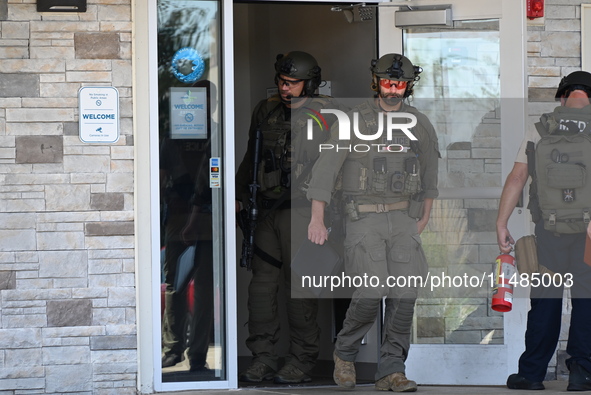 The SWAT team is raiding the WoodSpring Suites hotel in Carol Stream, Illinois, United States, on August 16, 2024. No information is immedia...