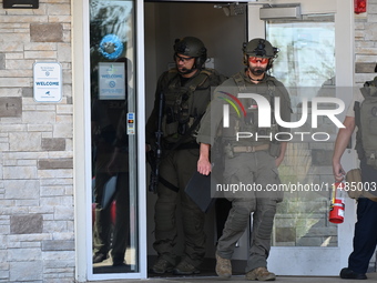 The SWAT team is raiding the WoodSpring Suites hotel in Carol Stream, Illinois, United States, on August 16, 2024. No information is immedia...