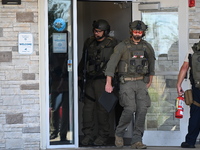 The SWAT team is raiding the WoodSpring Suites hotel in Carol Stream, Illinois, United States, on August 16, 2024. No information is immedia...