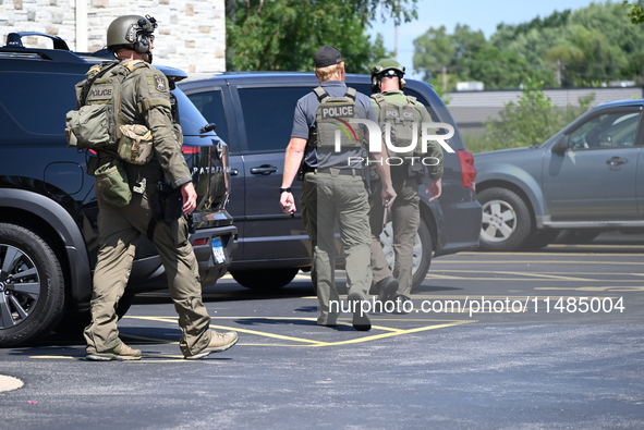 The SWAT team is raiding the WoodSpring Suites hotel in Carol Stream, Illinois, United States, on August 16, 2024. No information is immedia...