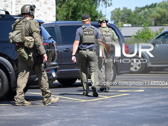 The SWAT team is raiding the WoodSpring Suites hotel in Carol Stream, Illinois, United States, on August 16, 2024. No information is immedia...