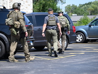 The SWAT team is raiding the WoodSpring Suites hotel in Carol Stream, Illinois, United States, on August 16, 2024. No information is immedia...