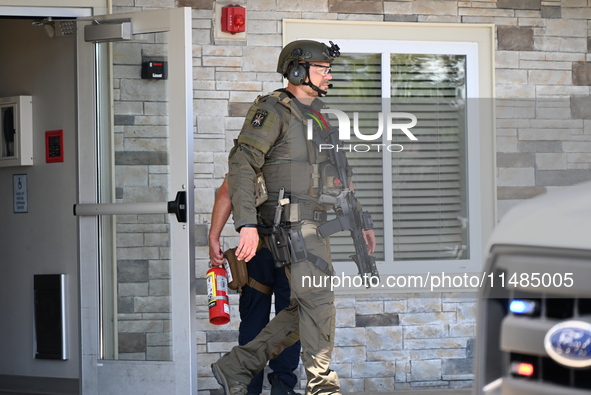 The SWAT team is raiding the WoodSpring Suites hotel in Carol Stream, Illinois, United States, on August 16, 2024. No information is immedia...