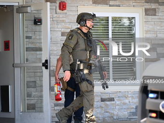 The SWAT team is raiding the WoodSpring Suites hotel in Carol Stream, Illinois, United States, on August 16, 2024. No information is immedia...