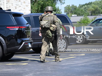 The SWAT team is raiding the WoodSpring Suites hotel in Carol Stream, Illinois, United States, on August 16, 2024. No information is immedia...