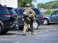 The SWAT team is raiding the WoodSpring Suites hotel in Carol Stream, Illinois, United States, on August 16, 2024. No information is immedia...